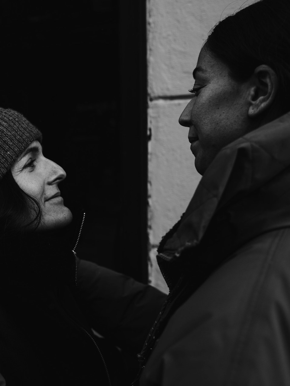 Two people facing each other in profile, black and white